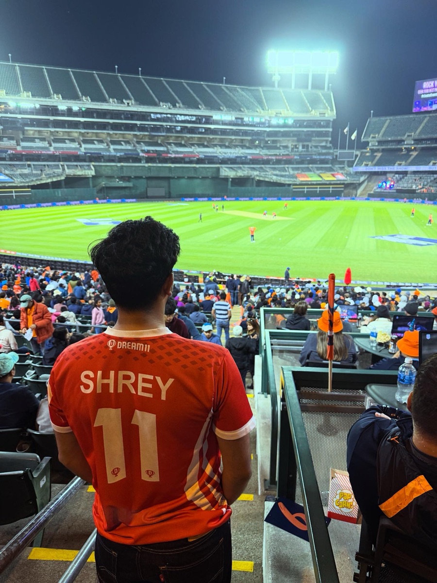 Shrey in a Dream11 jersey with his name at a cricket match