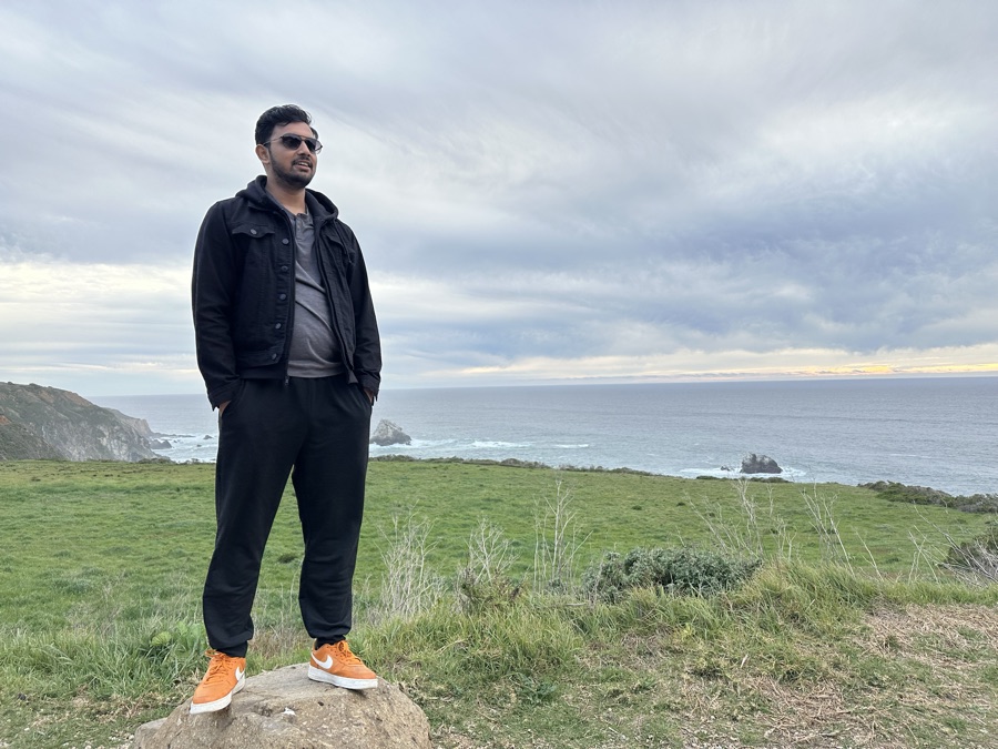 Shrey standing on a rock along Highway 1